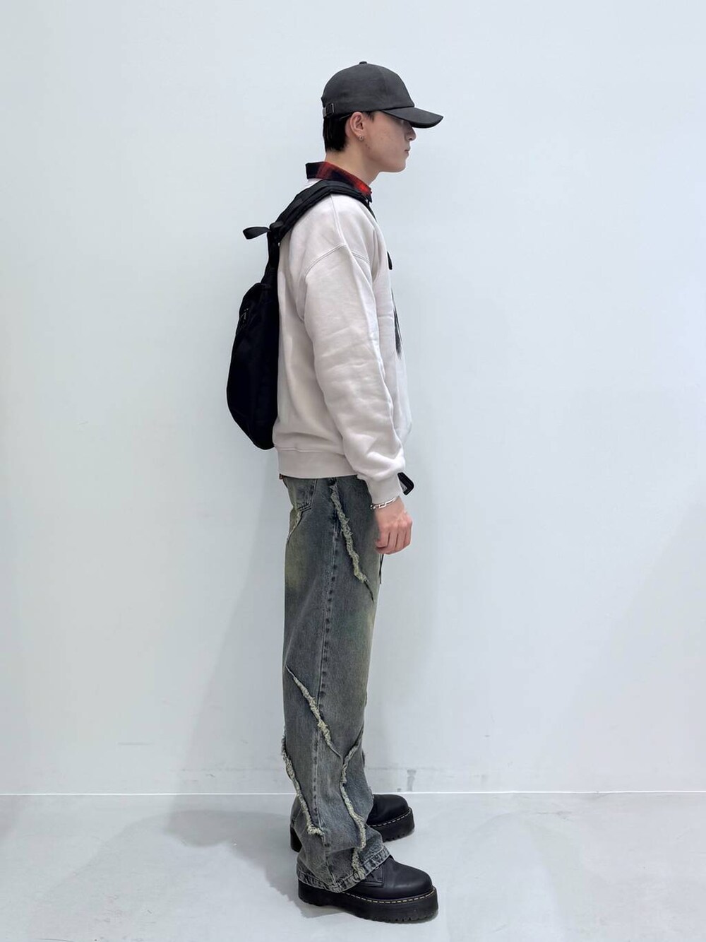 ブラック系のバックパック/リュック、レッド系のシャツ/ブラウス、グレー系のスウェットを着用したメンズの冬コーディネートの7枚目の写真