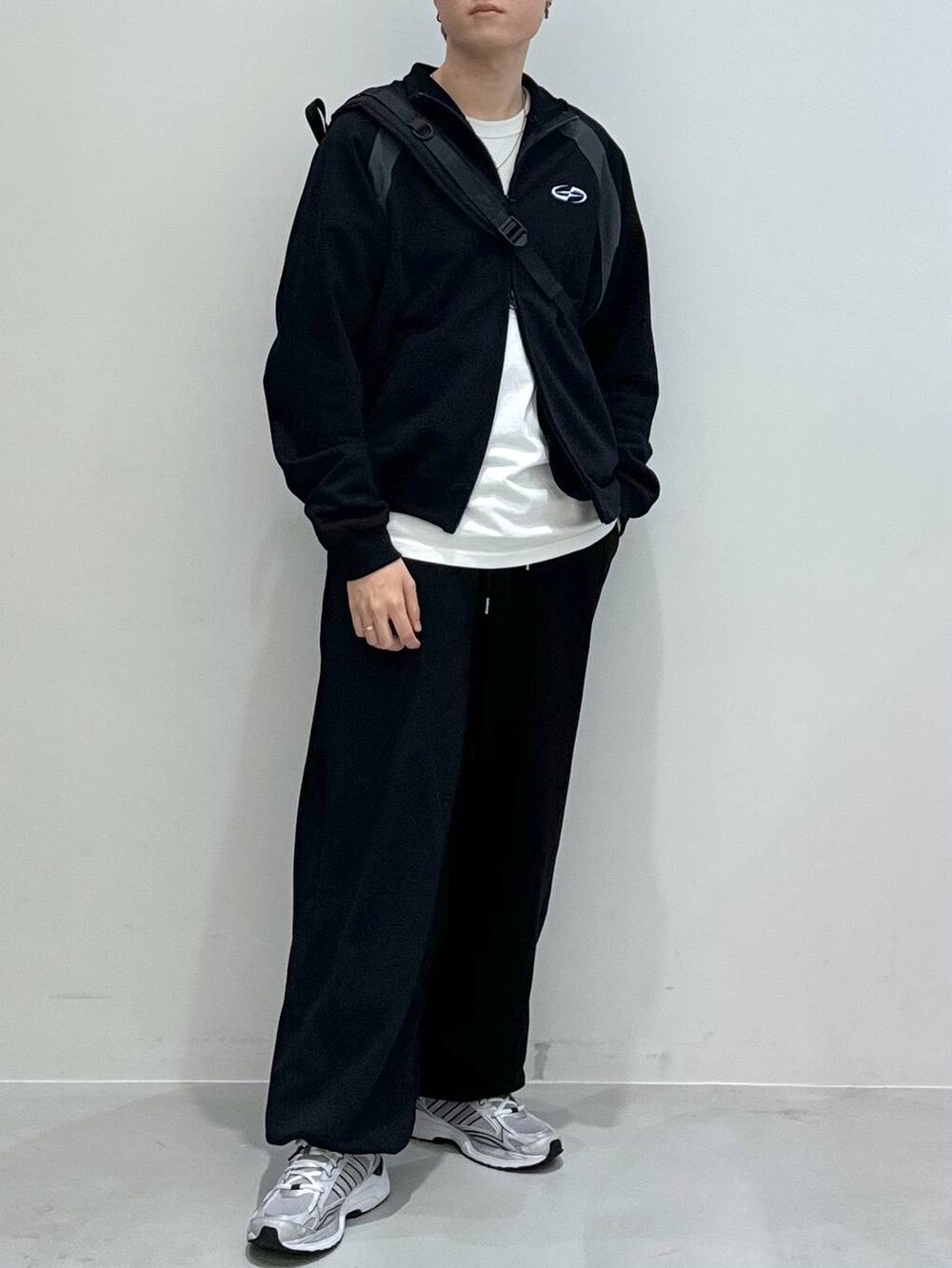 ブラック系のバックパック/リュック、ブラック系のスウェットパンツ、ホワイト系のTシャツ/カットソーを着用したメンズの冬コーディネートの7枚目の写真