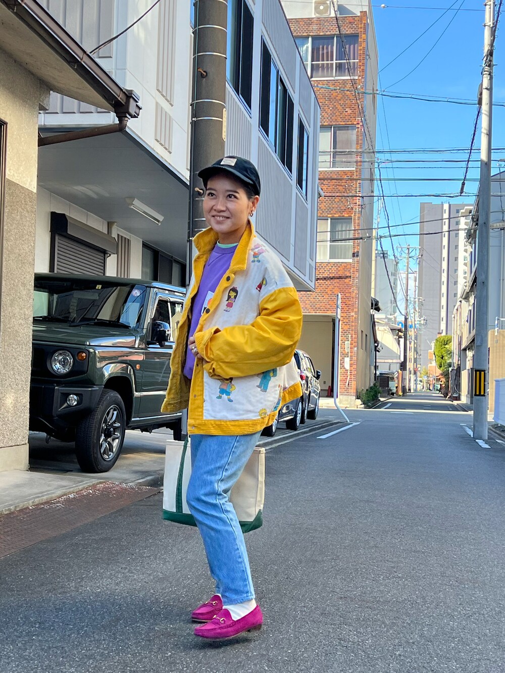 ブルー系のデニムパンツ、ピンク系のローファー、グリーン系のトートバッグを着用したレディースの冬コーディネートの4枚目の写真