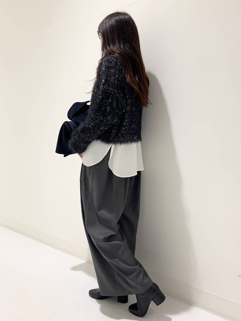 ブラック系のブーツ、ブラック系のハンドバッグ、グレー系のその他パンツを着用したレディースの冬コーディネートの5枚目の写真