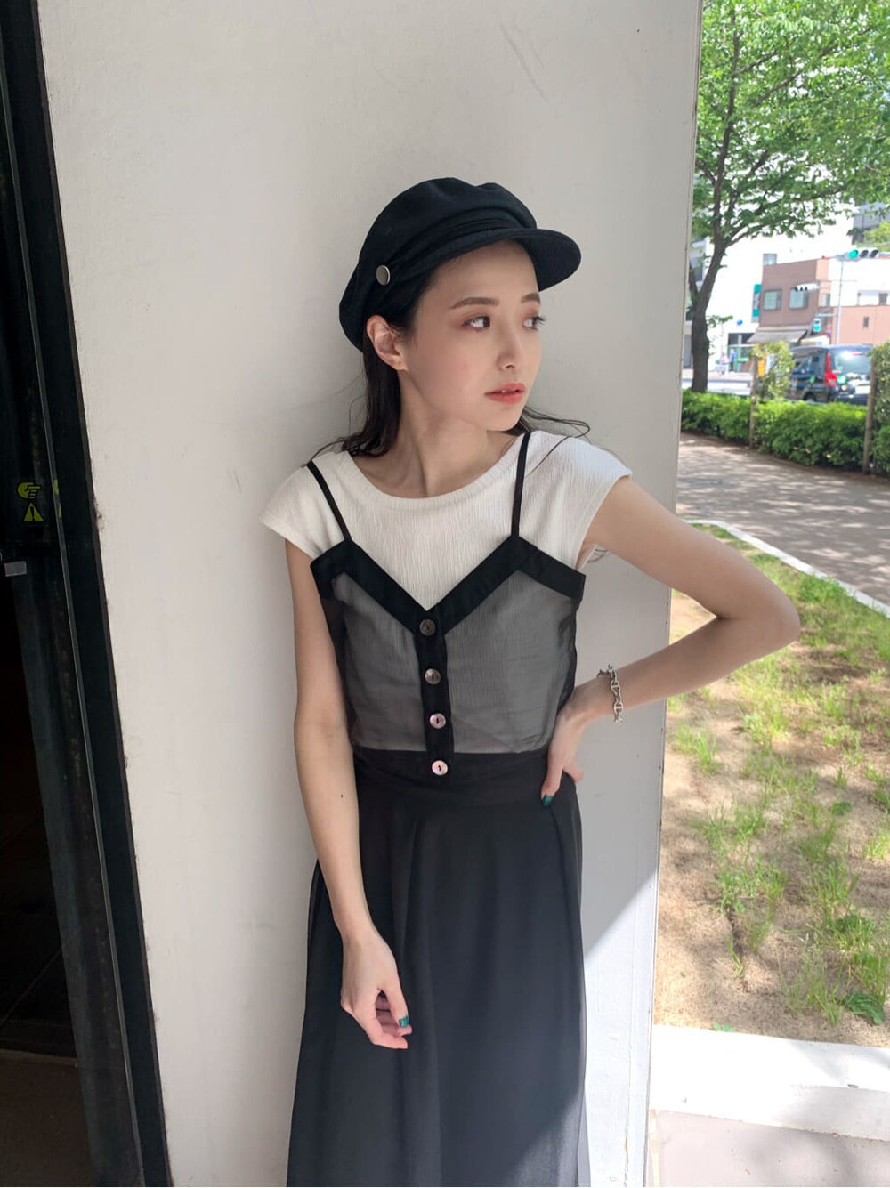 ホワイト系のサンダル、ブラック系のスカート、ブラック系のTシャツ/カットソーを着用したレディースの夏コーディネートの3枚目の写真