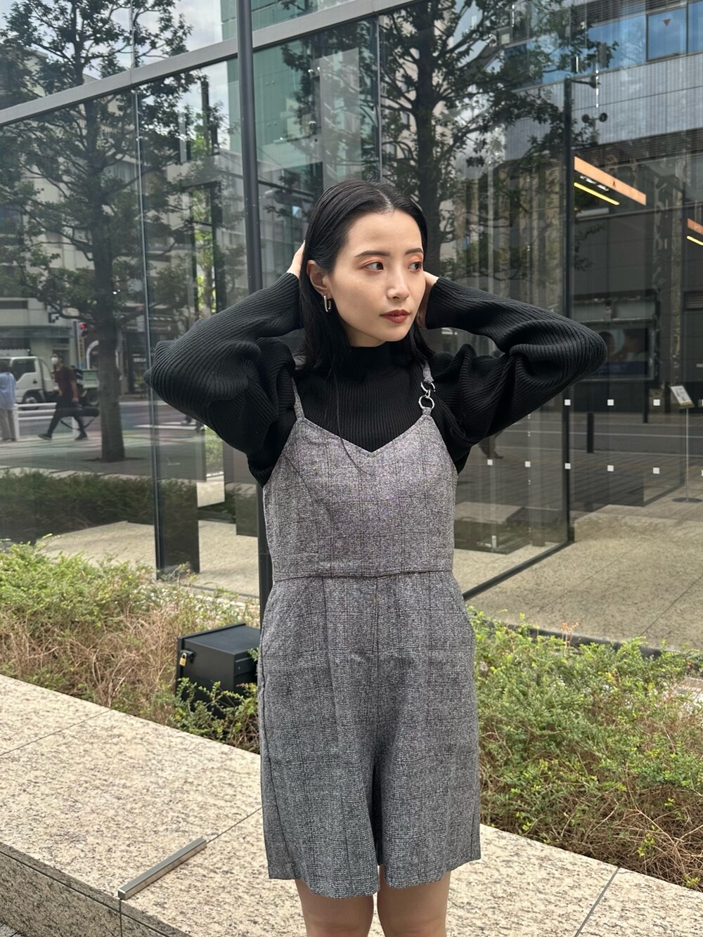 グレー系のワンピース、ブラック系のニット/セーター、ブラック系のブーツを着用したレディースの秋コーディネートの4枚目の写真