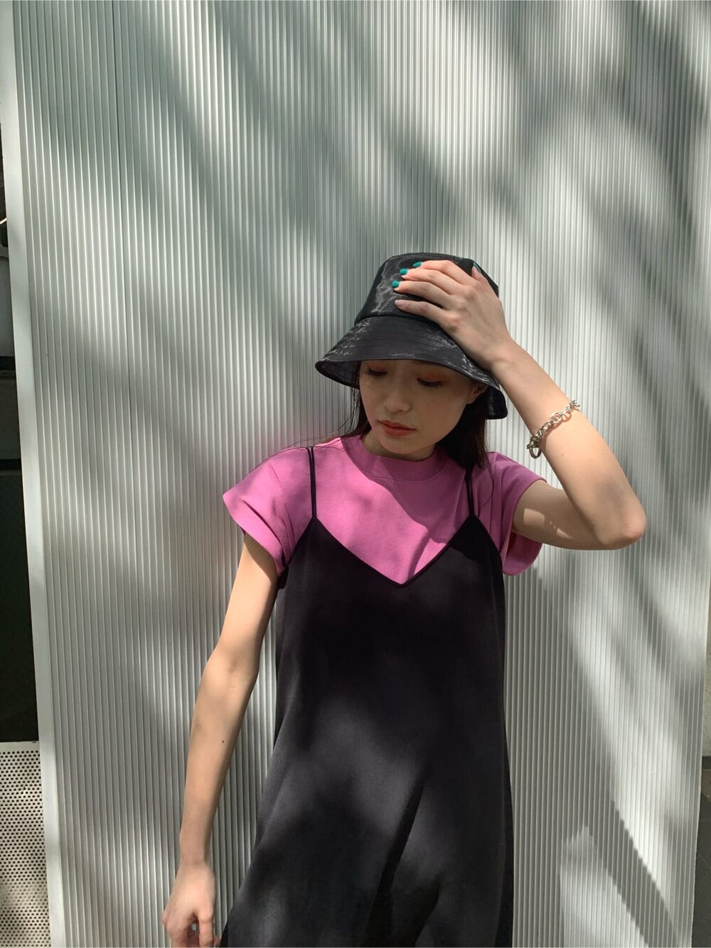 ピンク系のタンクトップ、ブラック系のワンピース、ブラック系のサンダルを着用したレディースの夏コーディネートの4枚目の写真