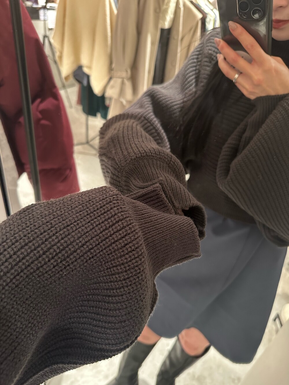 グレー系のワンピース、グレー系のダウンジャケット/コート、ブラック系のブーツを着用したレディースの冬コーディネートの7枚目の写真