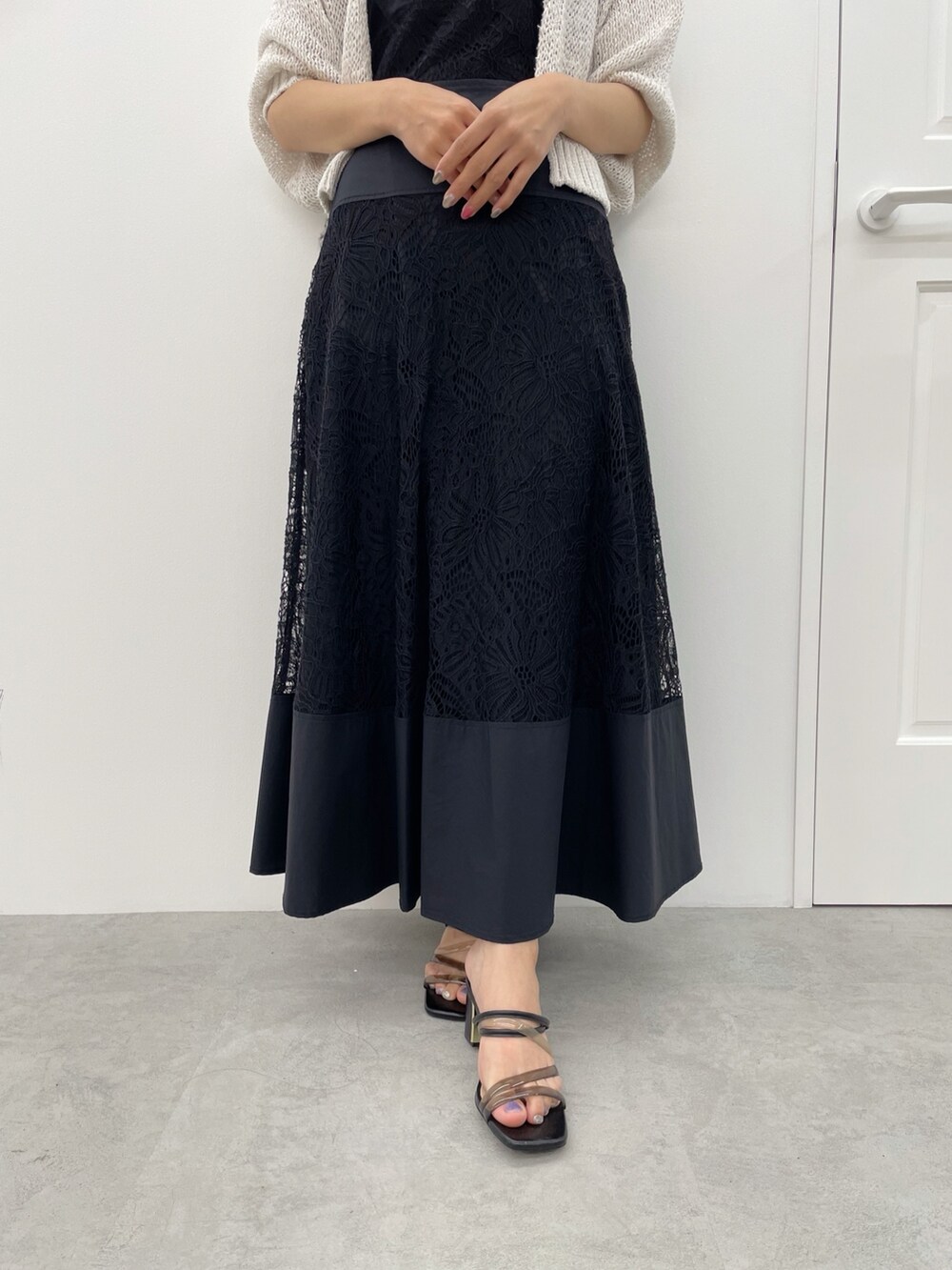 ブラック系のサンダル、ブラック系のワンピース、ベージュ系のカーディガン/ボレロを着用したレディースの春コーディネートの4枚目の写真