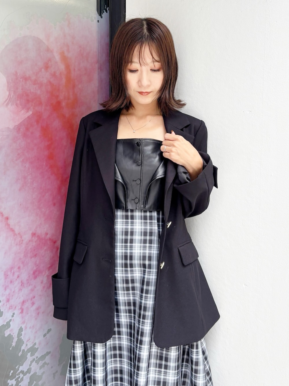 ブラック系のワンピース、ブラック系のブーツ、ブラック系のテーラードジャケットを着用したレディースの秋コーディネートの2枚目の写真