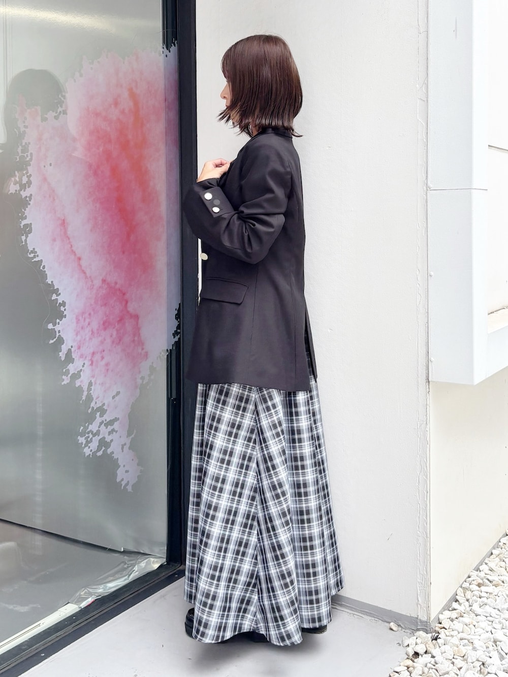 ブラック系のワンピース、ブラック系のブーツ、ブラック系のテーラードジャケットを着用したレディースの秋コーディネートの5枚目の写真