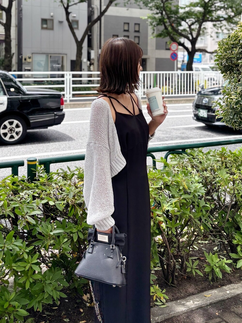 ブラック系のワンピース、グレー系のカーディガン/ボレロを着用したレディースの夏コーディネートの8枚目の写真