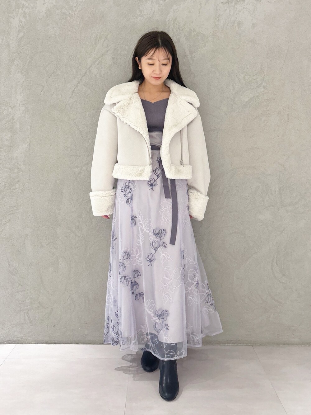 パープル系のワンピース、ブラック系のブーツ、グレー系のムートンコートを着用したレディースの秋コーディネートの7枚目の写真