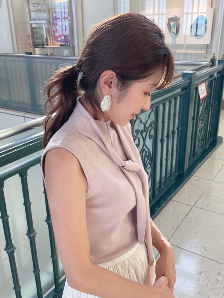 ホワイト系のスカート、ベージュ系のパンプス、ピンク系のニット/セーターを着用したレディースの秋コーディネートの3枚目の写真