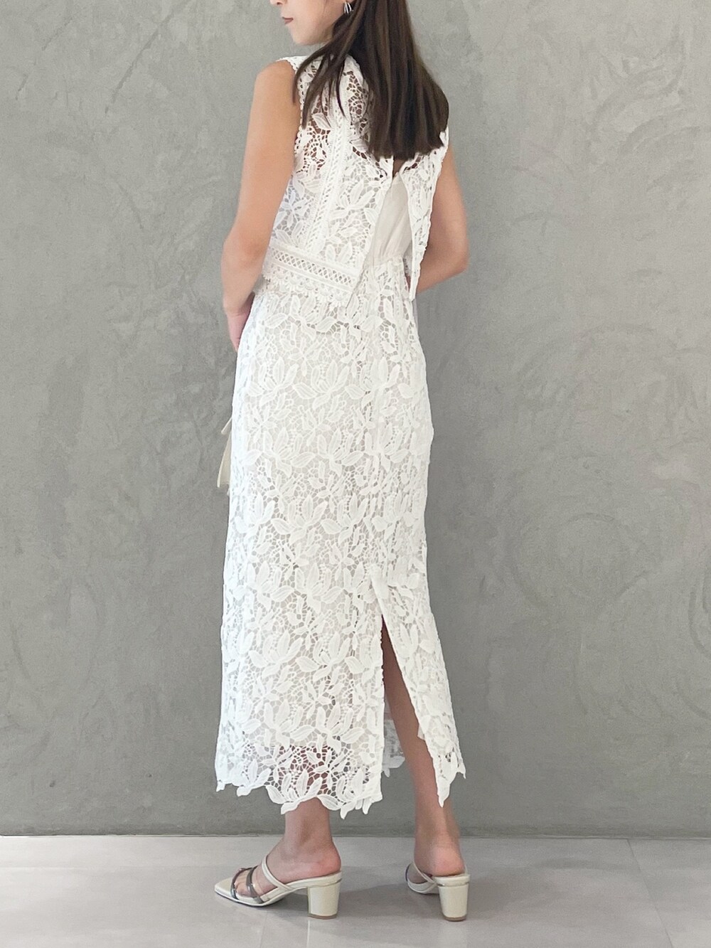 ベージュ系のショルダーバッグ、ホワイト系のサンダル、パープル系のカーディガン/ボレロを着用したレディースの夏コーディネートの4枚目の写真