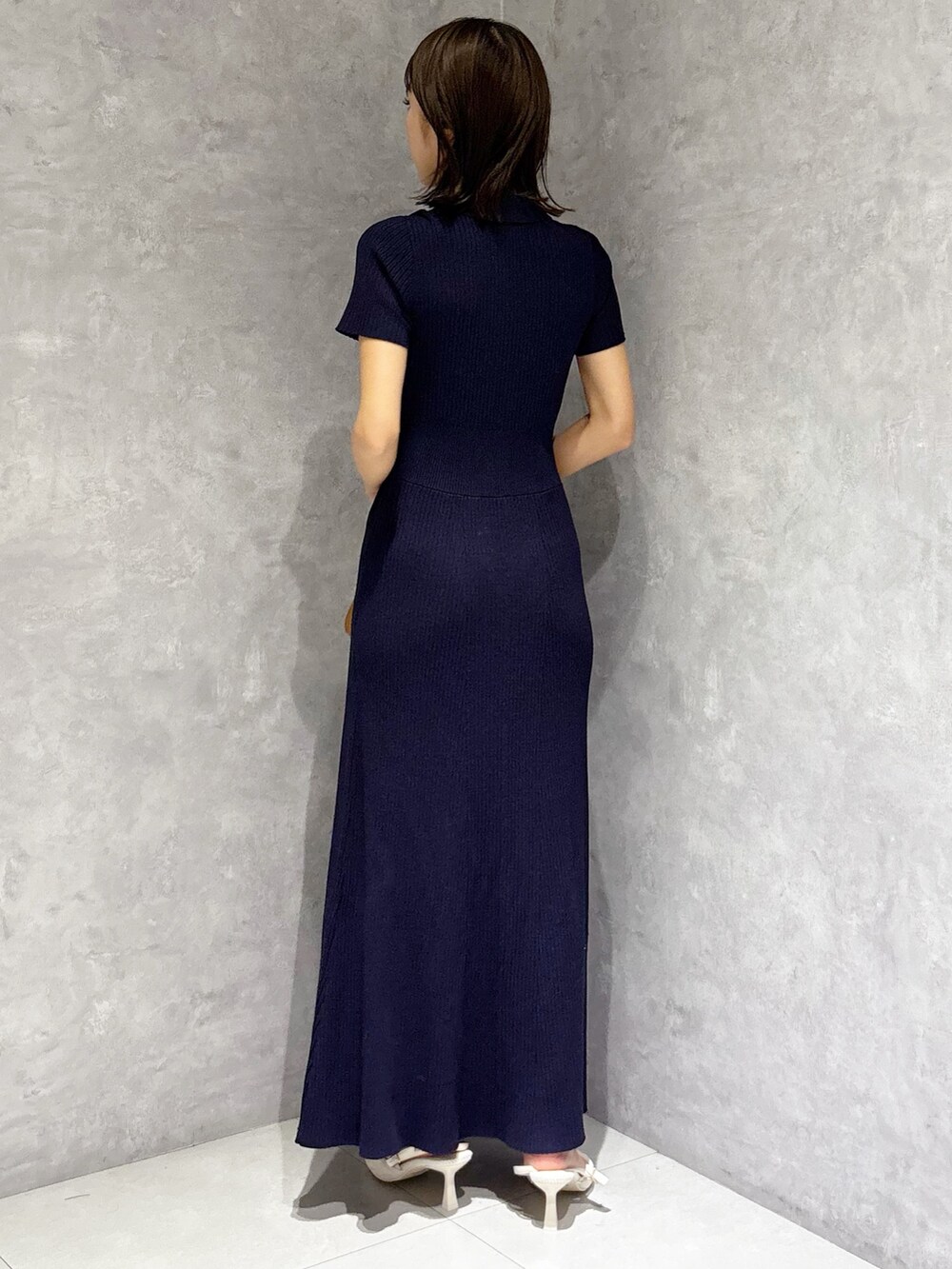 ブラウン系のハンドバッグ、ホワイト系のパンプス、ブルー系のワンピースを着用したレディースの春コーディネートの4枚目の写真