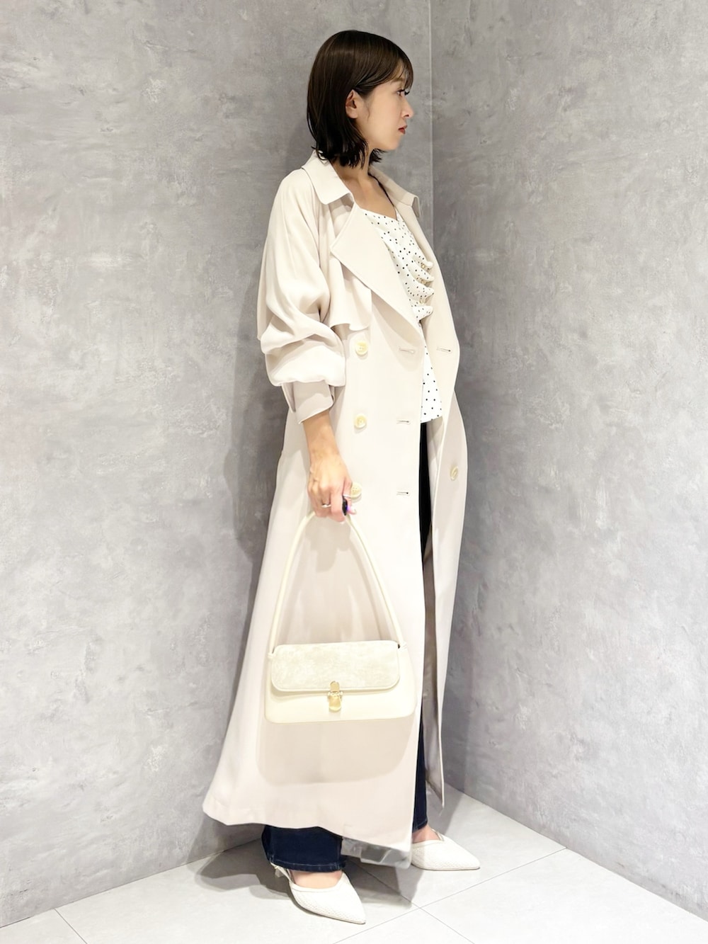 ホワイト系のシャツ/ブラウス、ブルー系のデニムパンツ、ホワイト系のトレンチコートを着用したレディースの春コーディネートの2枚目の写真