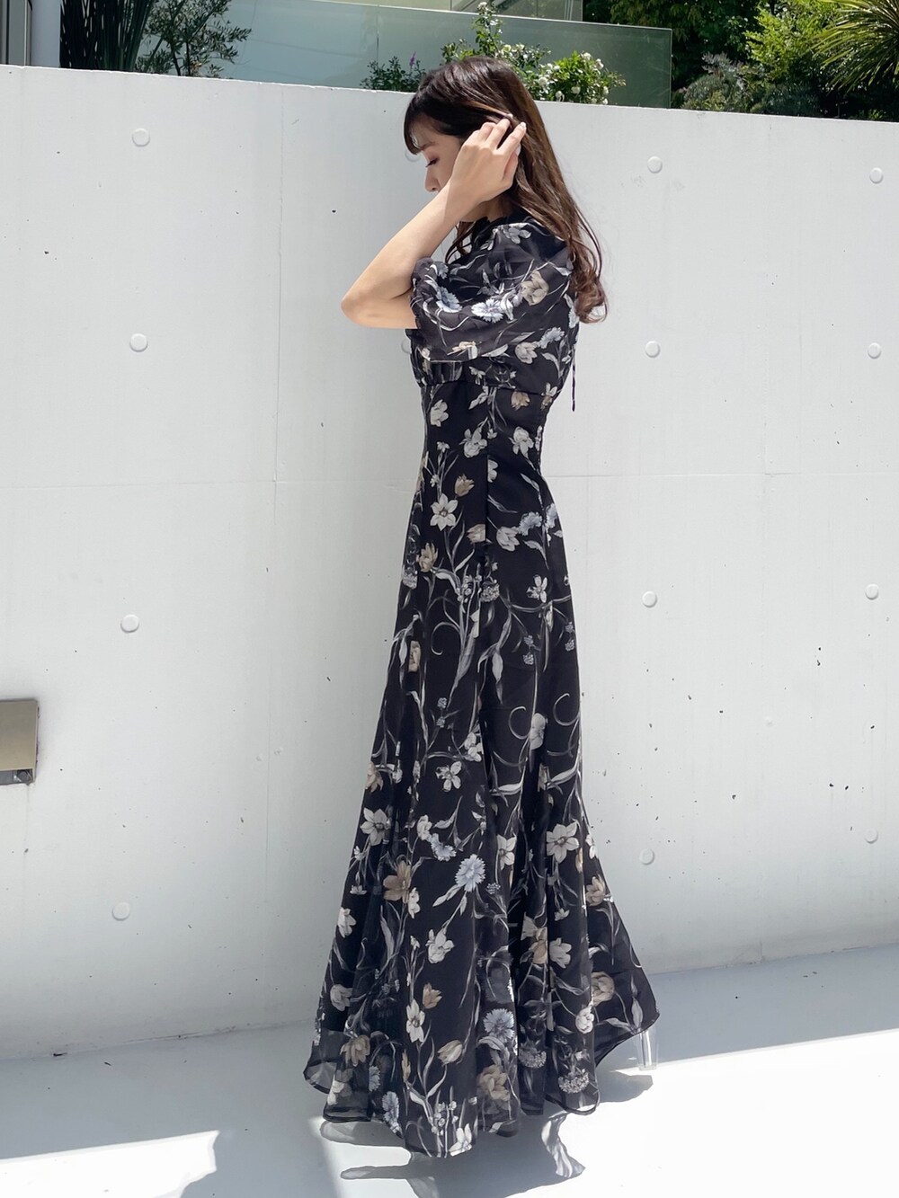 ブラック系のハンドバッグ、ブラック系のワンピースを着用したレディースの夏コーディネートの6枚目の写真