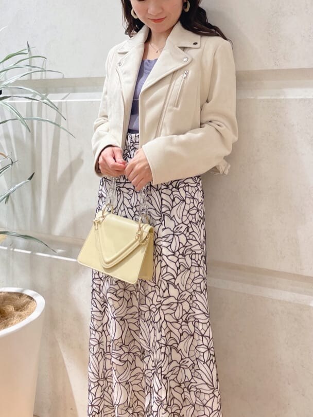 イエロー系のショルダーバッグ、ホワイト系のテーラードジャケット、グリーン系のサンダルを着用したレディースの春コーディネートの2枚目の写真