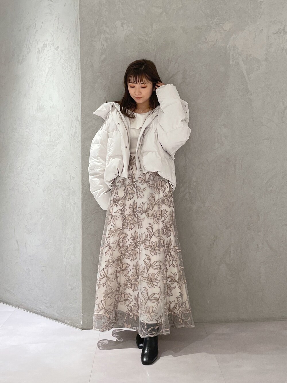 ホワイト系のダウンジャケット/コート、ホワイト系のニット/セーター、ピンク系のスカートを着用したレディースの冬コーディネートの8枚目の写真