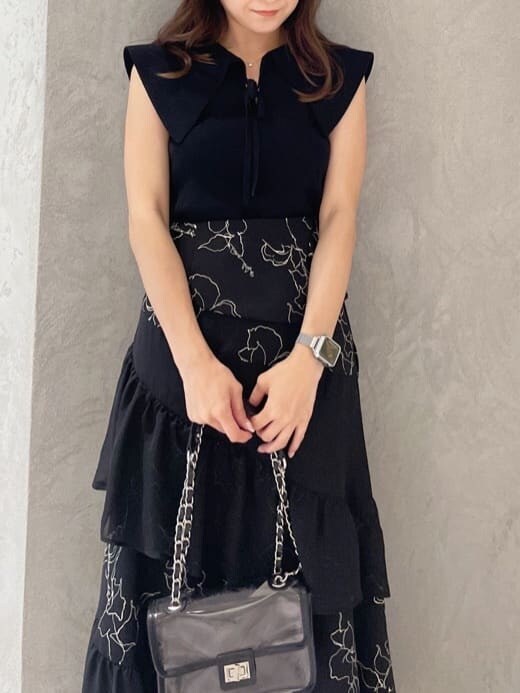 ブラック系のショルダーバッグ、ブラック系のニット/セーター、ブラック系のスカートを着用したレディースの夏コーディネートの2枚目の写真