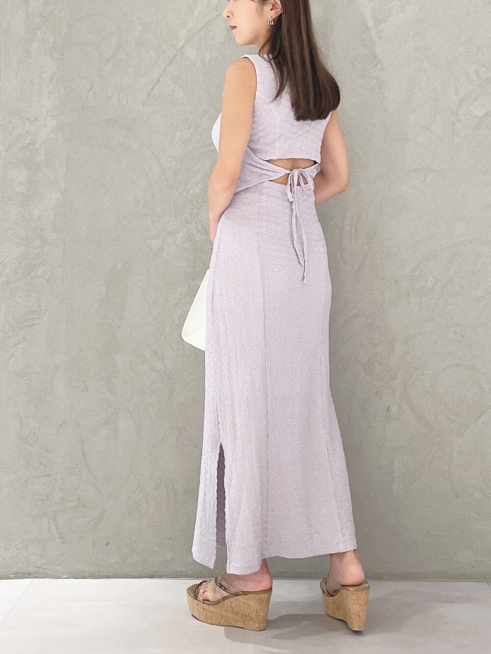 ホワイト系のショルダーバッグ、ブラウン系のサンダル、パープル系のワンピースを着用したレディースの夏コーディネートの4枚目の写真