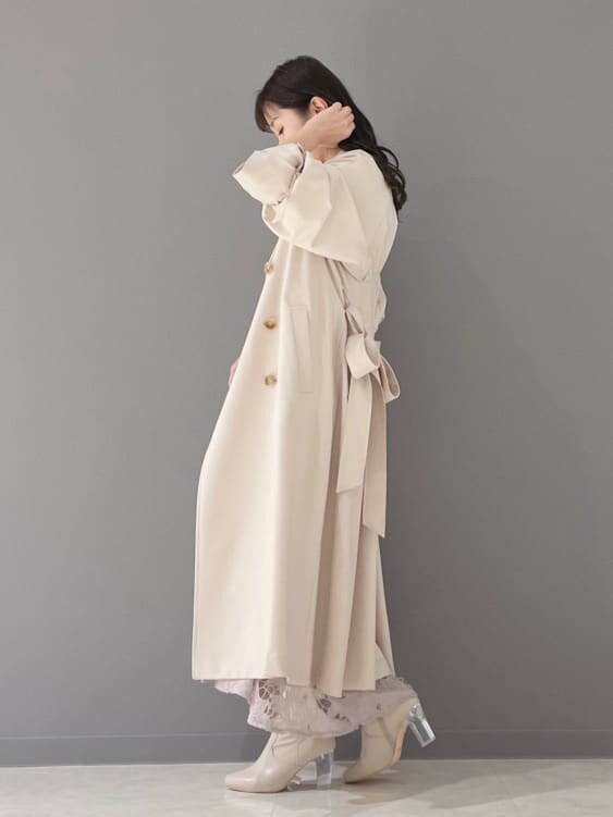 ベージュ系のその他シューズ、ベージュ系のトレンチコート、イエロー系のショルダーバッグを着用したレディースの冬コーディネートの7枚目の写真