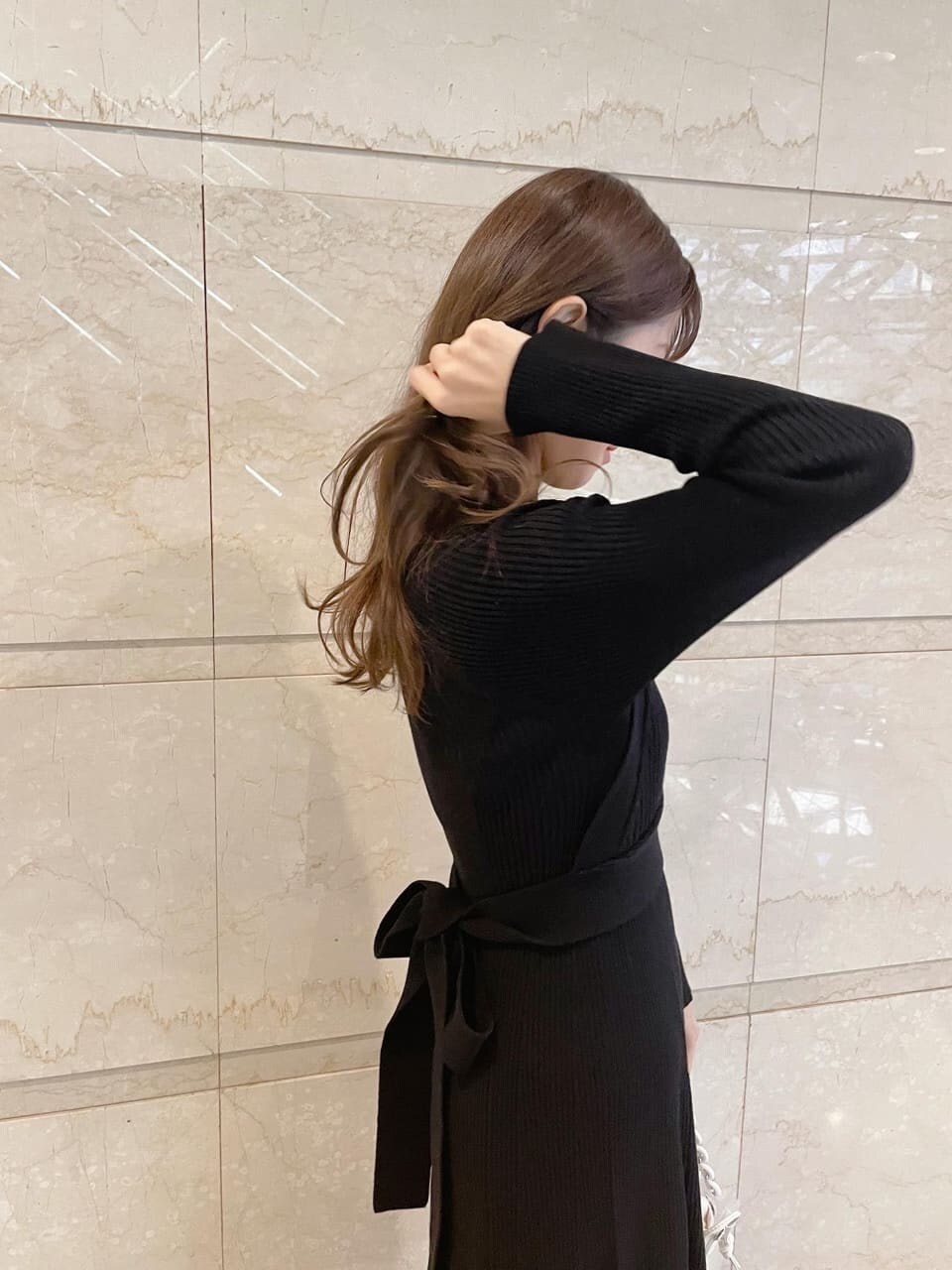 ブラック系のワンピース、ブラック系のその他シューズ、イエロー系のショルダーバッグを着用したレディースの冬コーディネートの6枚目の写真