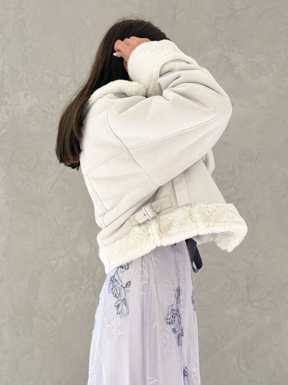 パープル系のワンピース、ブラック系のブーツ、グレー系のムートンコートを着用したレディースの秋コーディネートの4枚目の写真