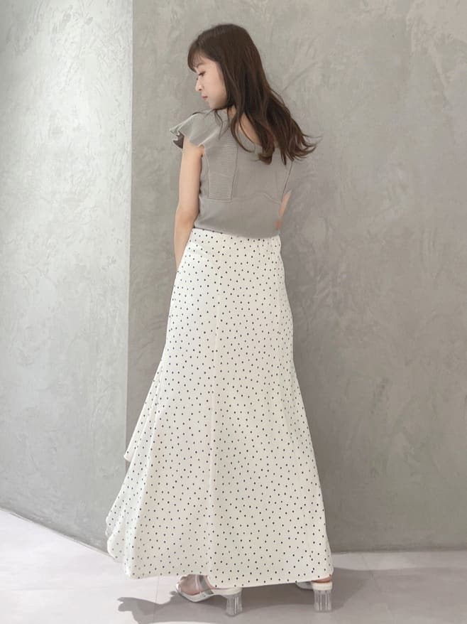 ホワイト系のハンドバッグ、グリーン系のサンダル、ホワイト系のスカートを着用したレディースの春コーディネートの7枚目の写真