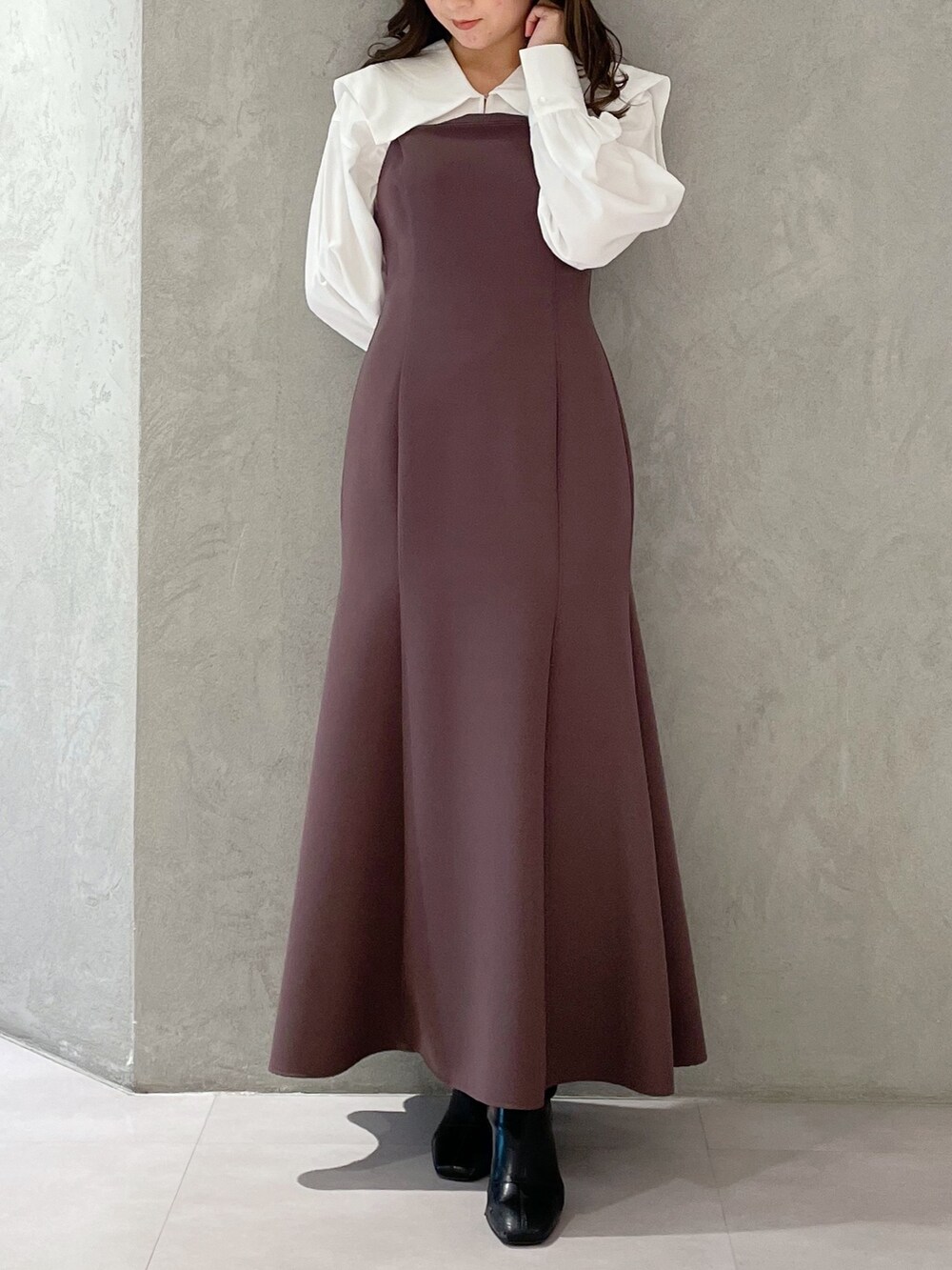 パープル系のワンピースを着用したレディースの冬コーディネートの2枚目の写真