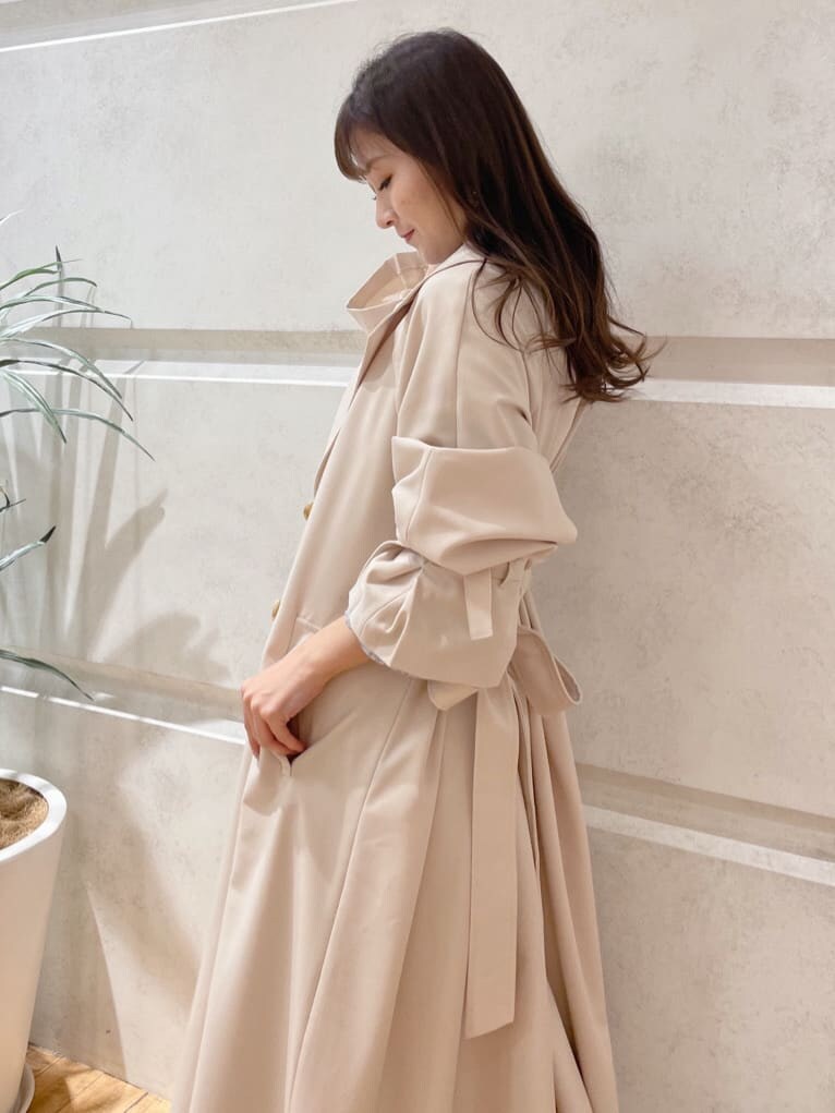 ベージュ系のその他シューズ、ベージュ系のトレンチコート、ブルー系のワンピースを着用したレディースの冬コーディネートの5枚目の写真