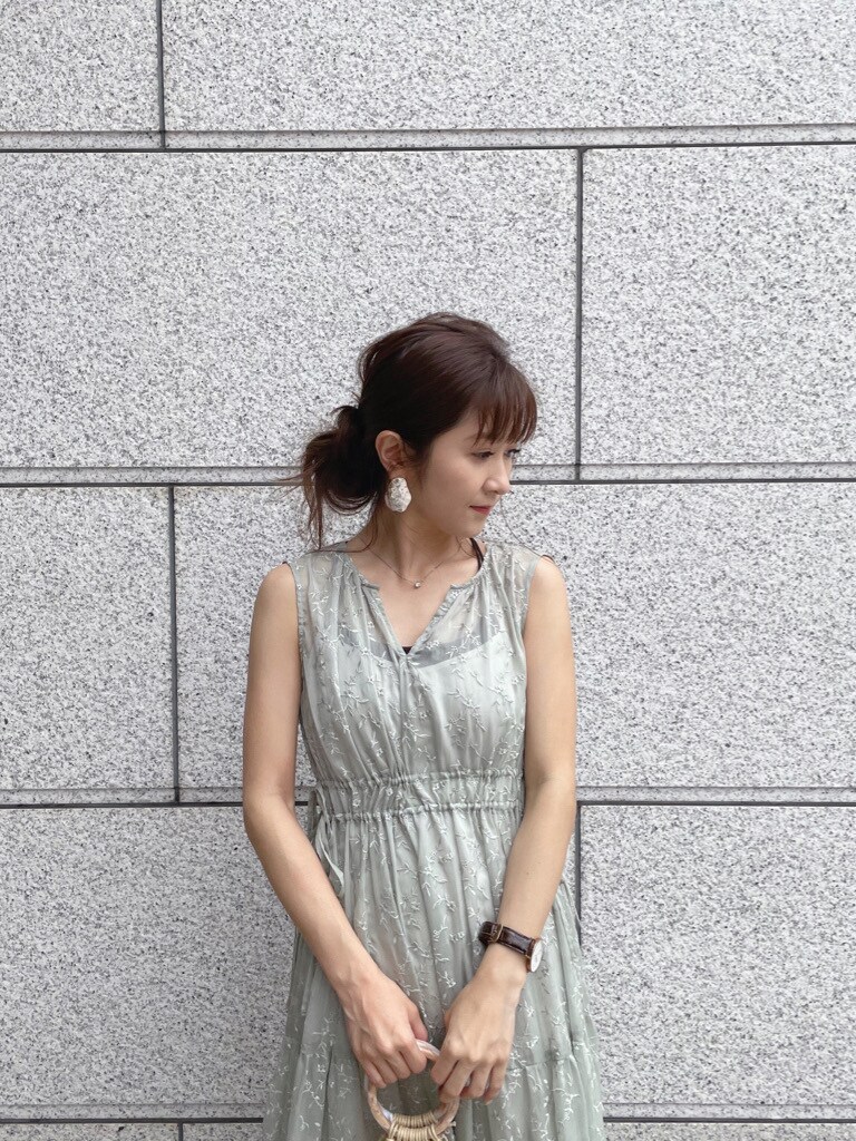 ベージュ系のサンダル、ホワイト系のハンドバッグ、グリーン系のワンピースを着用したレディースの春コーディネートの4枚目の写真