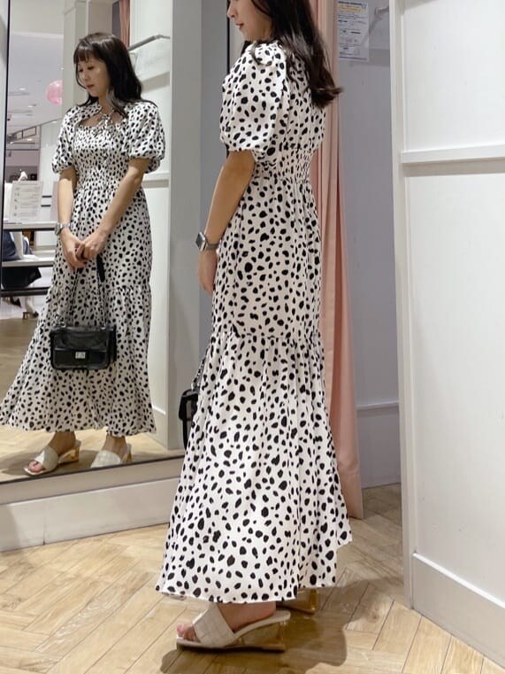 ブラック系のショルダーバッグ、ホワイト系のワンピースを着用したレディースの夏コーディネートの2枚目の写真