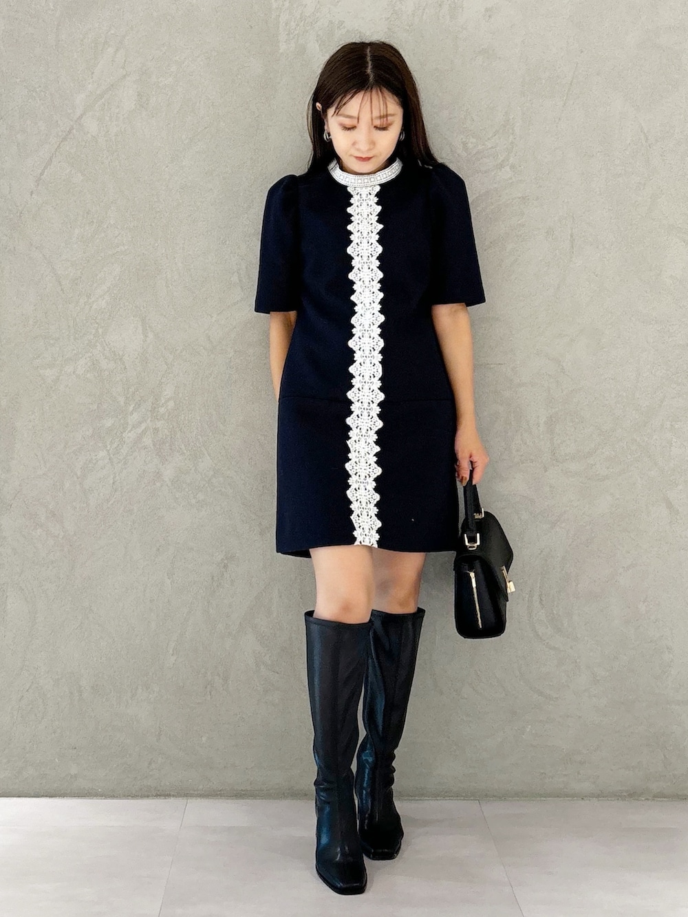 ブルー系のワンピース、ブラック系のブーツ、ブラック系のショルダーバッグを着用したレディースの秋コーディネートの6枚目の写真