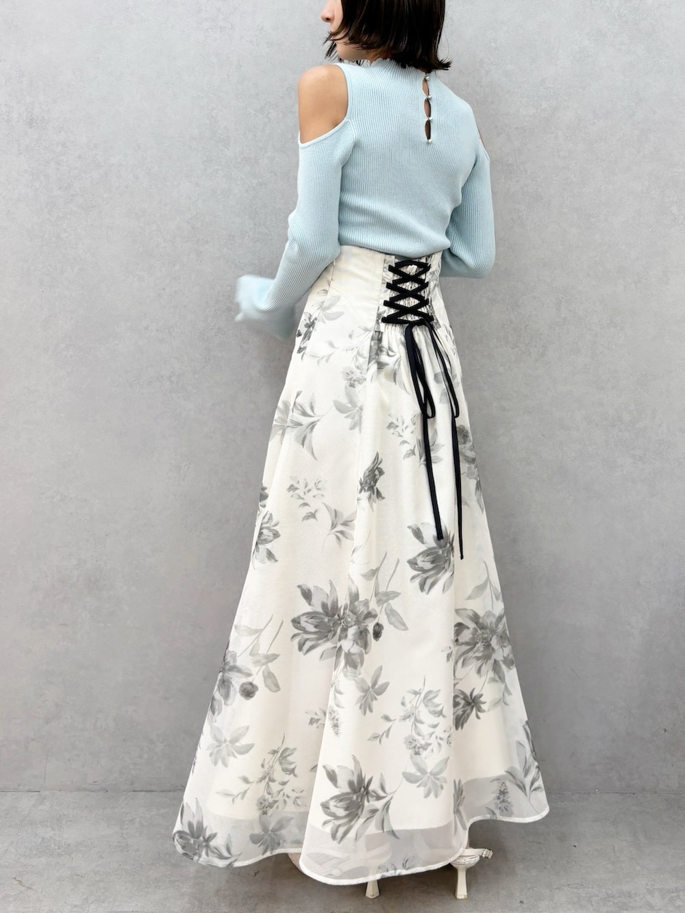 ホワイト系のスカート、グリーン系のニット/セーター、ホワイト系のパンプスを着用したレディースの春コーディネートの6枚目の写真