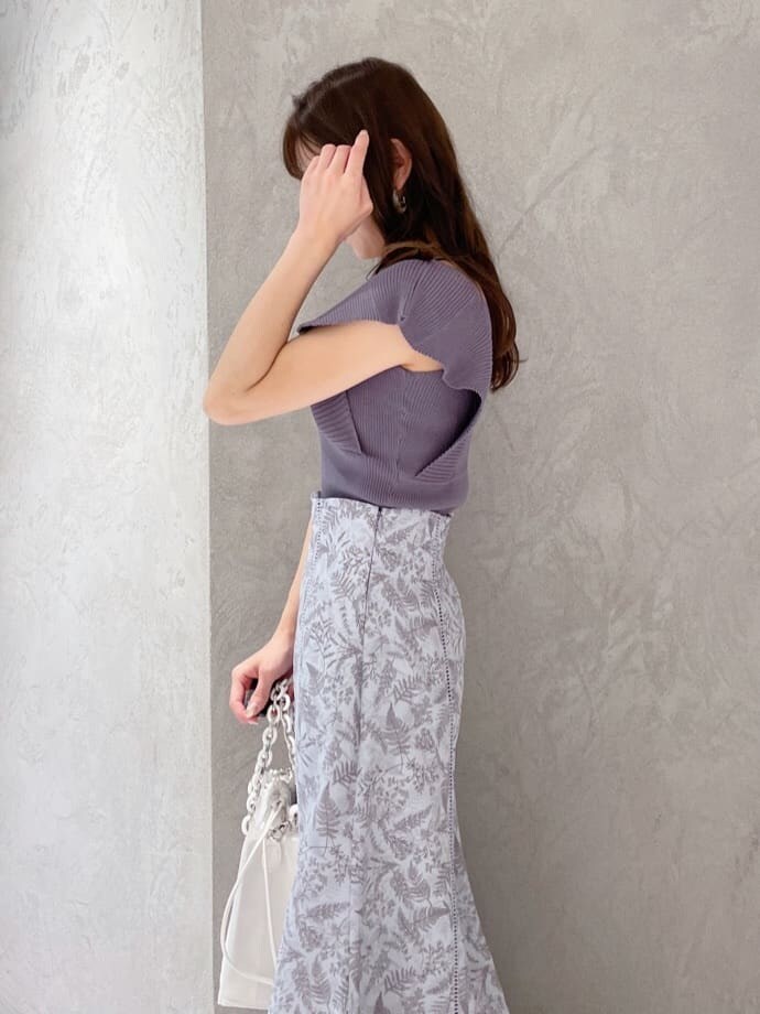 ホワイト系のハンドバッグ、グリーン系のサンダル、ブルー系のニット/セーターを着用したレディースの春コーディネートの5枚目の写真