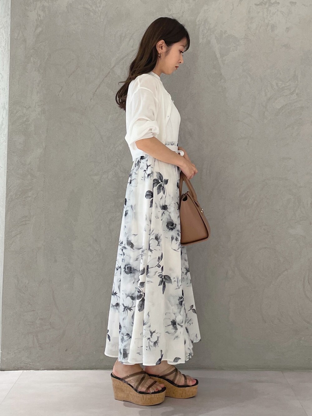 ホワイト系のワンピース、ブラック系のサンダル、ブラウン系のトートバッグを着用したレディースの夏コーディネートの4枚目の写真