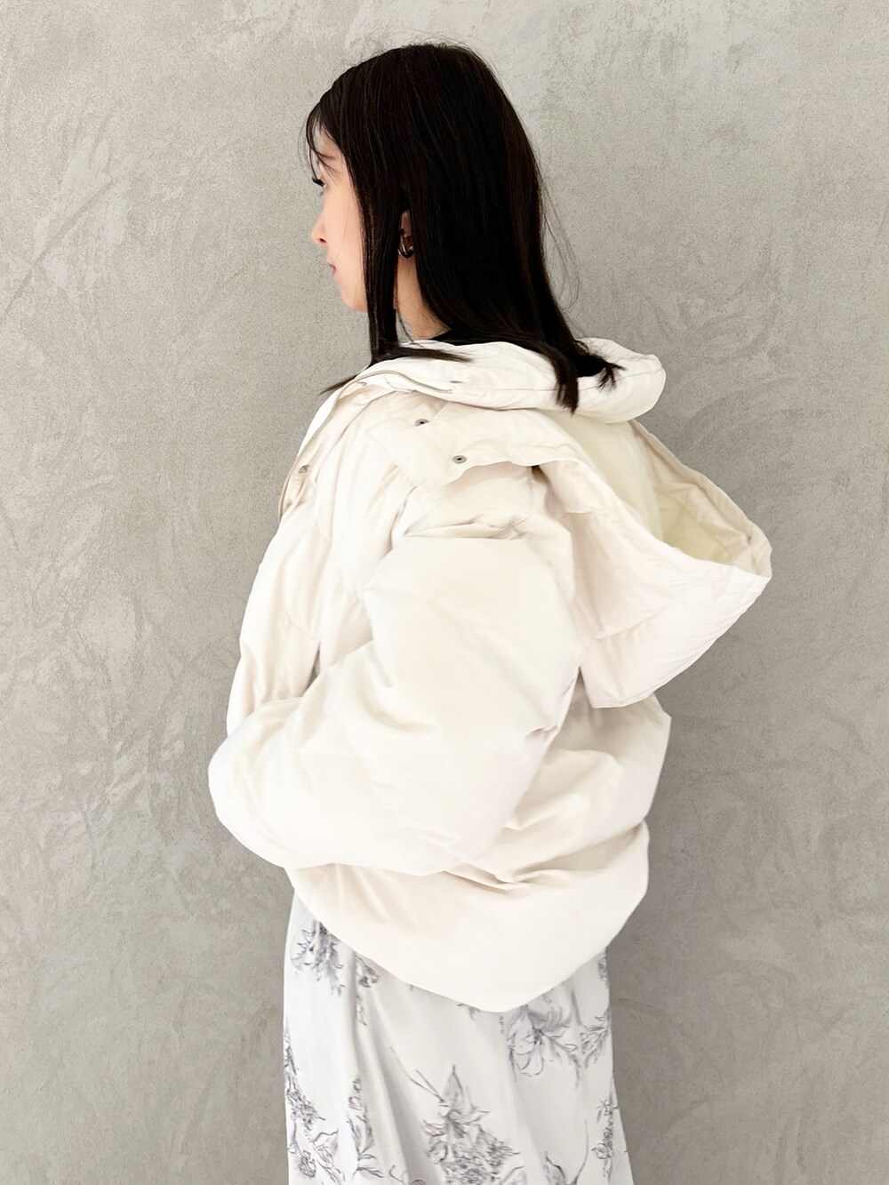 ブラック系のワンピース、ブラック系のブーツ、ホワイト系のハンドバッグを着用したレディースの秋コーディネートの4枚目の写真