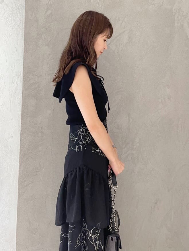 ブラック系のショルダーバッグ、ブラック系のニット/セーター、ブラック系のスカートを着用したレディースの夏コーディネートの4枚目の写真