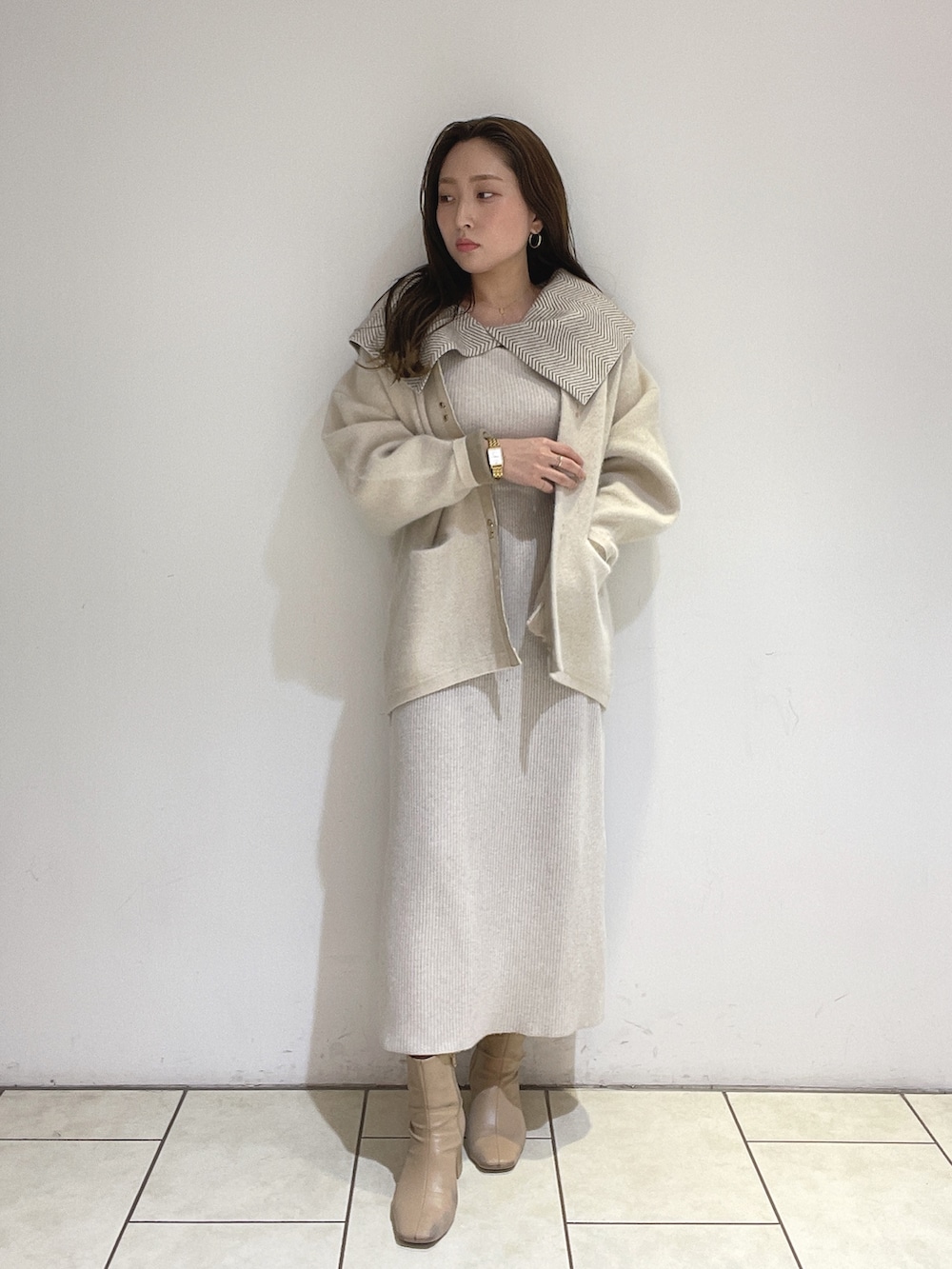 ホワイト系のワンピース、ホワイト系のカーディガン/ボレロ、ベージュ系のブーツを着用したレディースの冬コーディネートの4枚目の写真