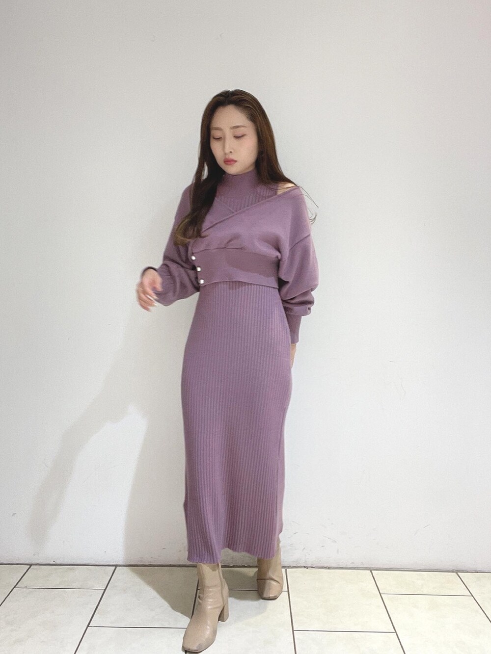 パープル系のワンピース、ベージュ系のブーツを着用したレディースの冬コーディネートの4枚目の写真