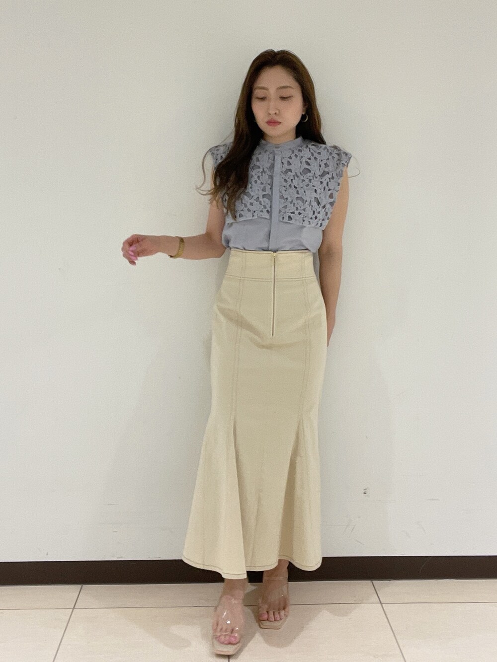 ホワイト系のスカート、その他のサンダル、ブルー系のシャツ/ブラウスを着用したレディースの春コーディネートの2枚目の写真