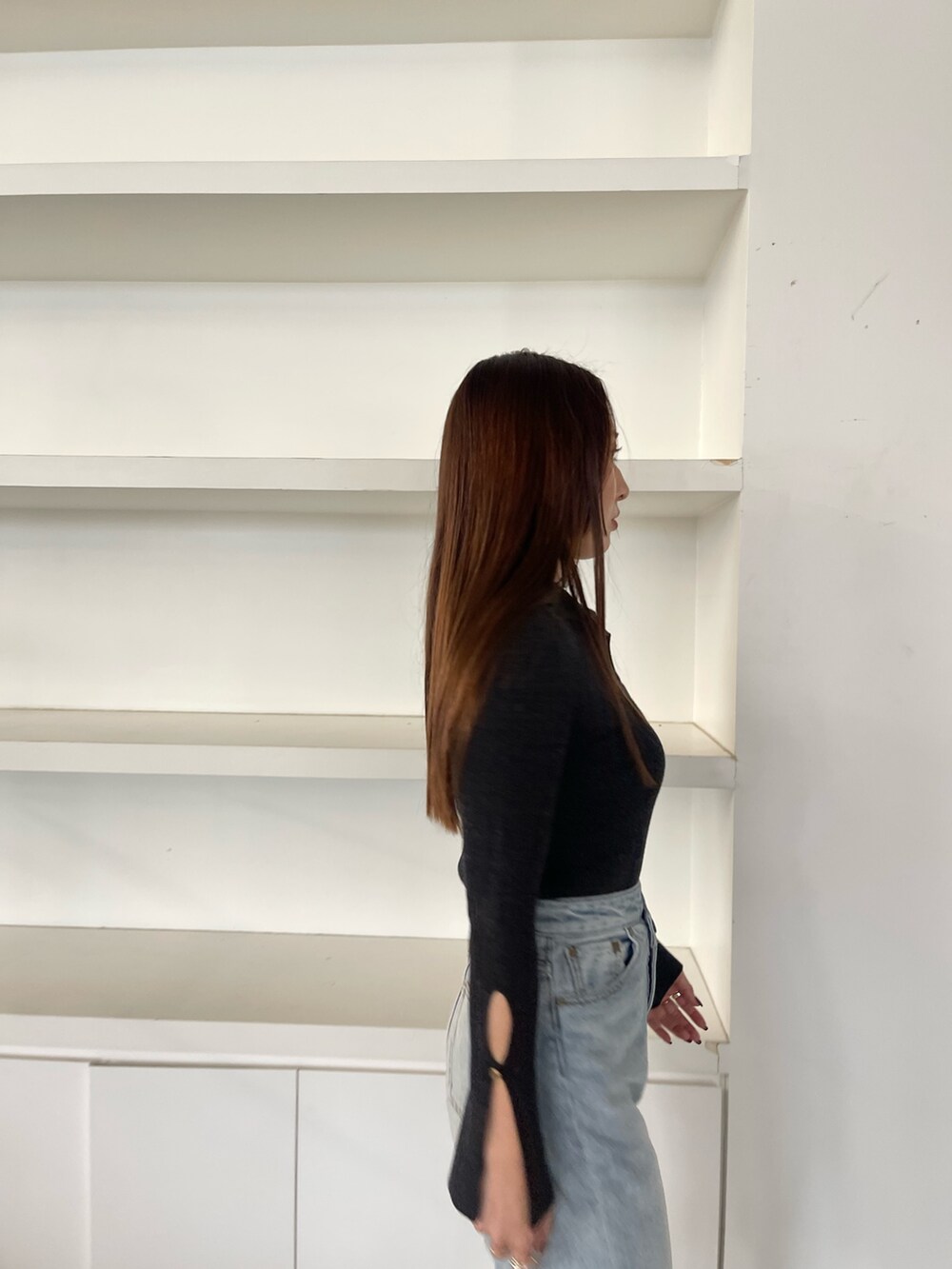 ブルー系のデニムパンツ、ブラック系のニット/セーターを着用したレディースの冬コーディネートの7枚目の写真