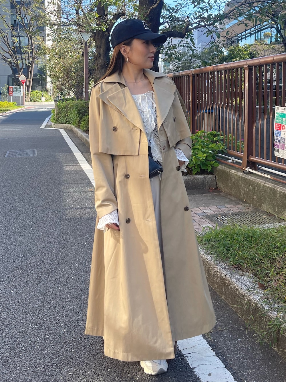 ホワイト系のシャツ/ブラウス、ベージュ系のトレンチコート、ホワイト系のその他パンツを着用したレディースの冬コーディネートの3枚目の写真