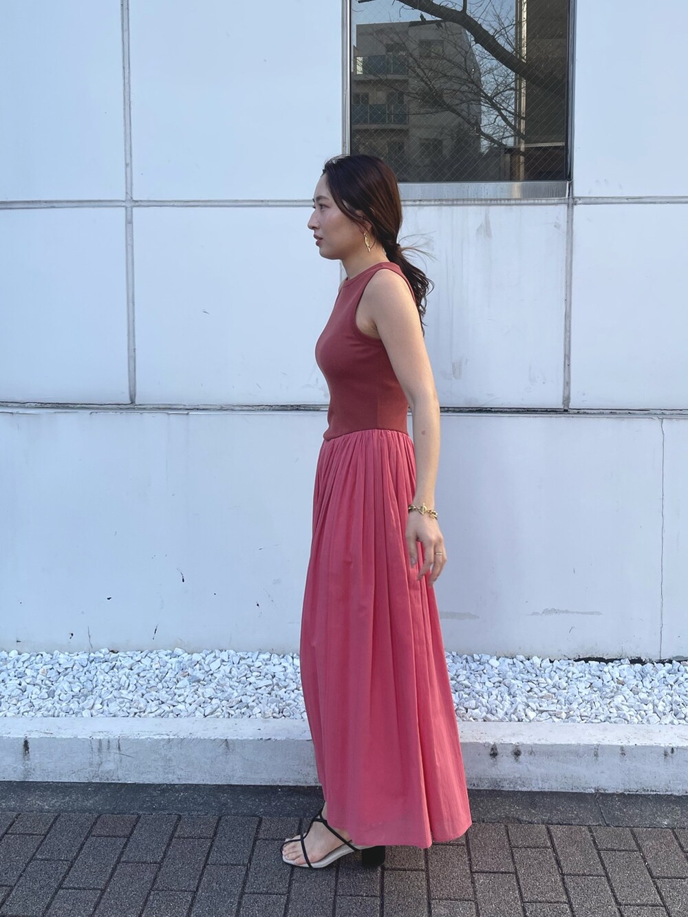 ブラック系のサンダル、ピンク系のワンピースを着用したレディースの春コーディネートの4枚目の写真