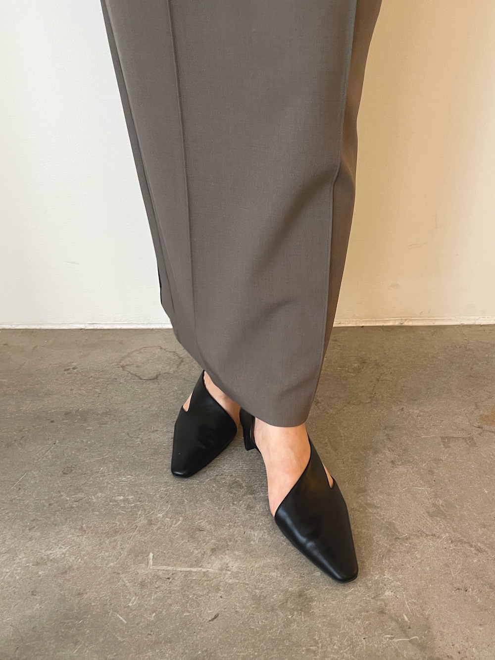 ブラック系のパンプス、グレー系のスカート、ベージュ系のニット/セーターを着用したレディースの秋コーディネートの8枚目の写真