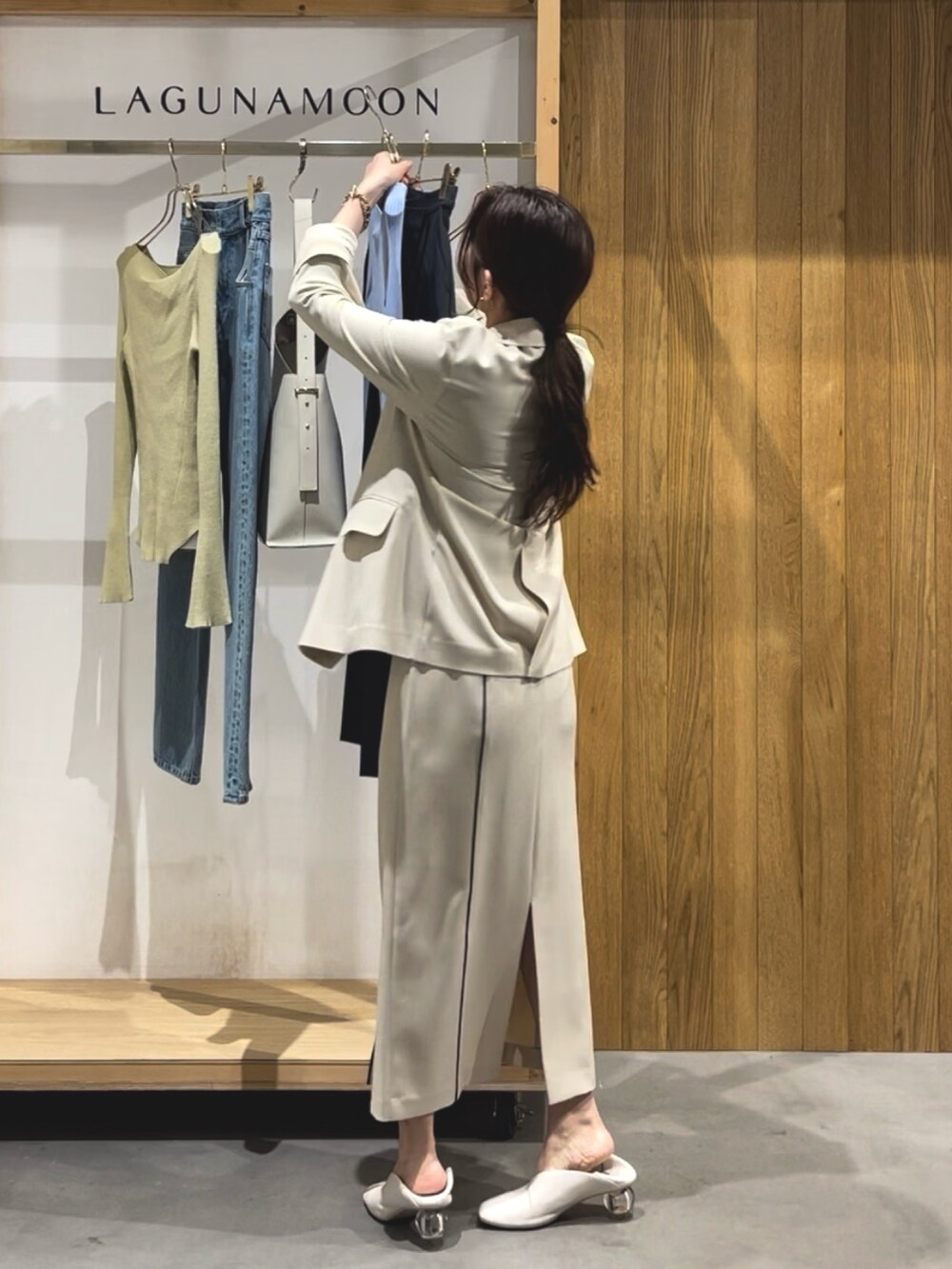 ベージュ系のスカート、ホワイト系のパンプス、ブラック系のニット/セーターを着用したレディースの冬コーディネートの4枚目の写真