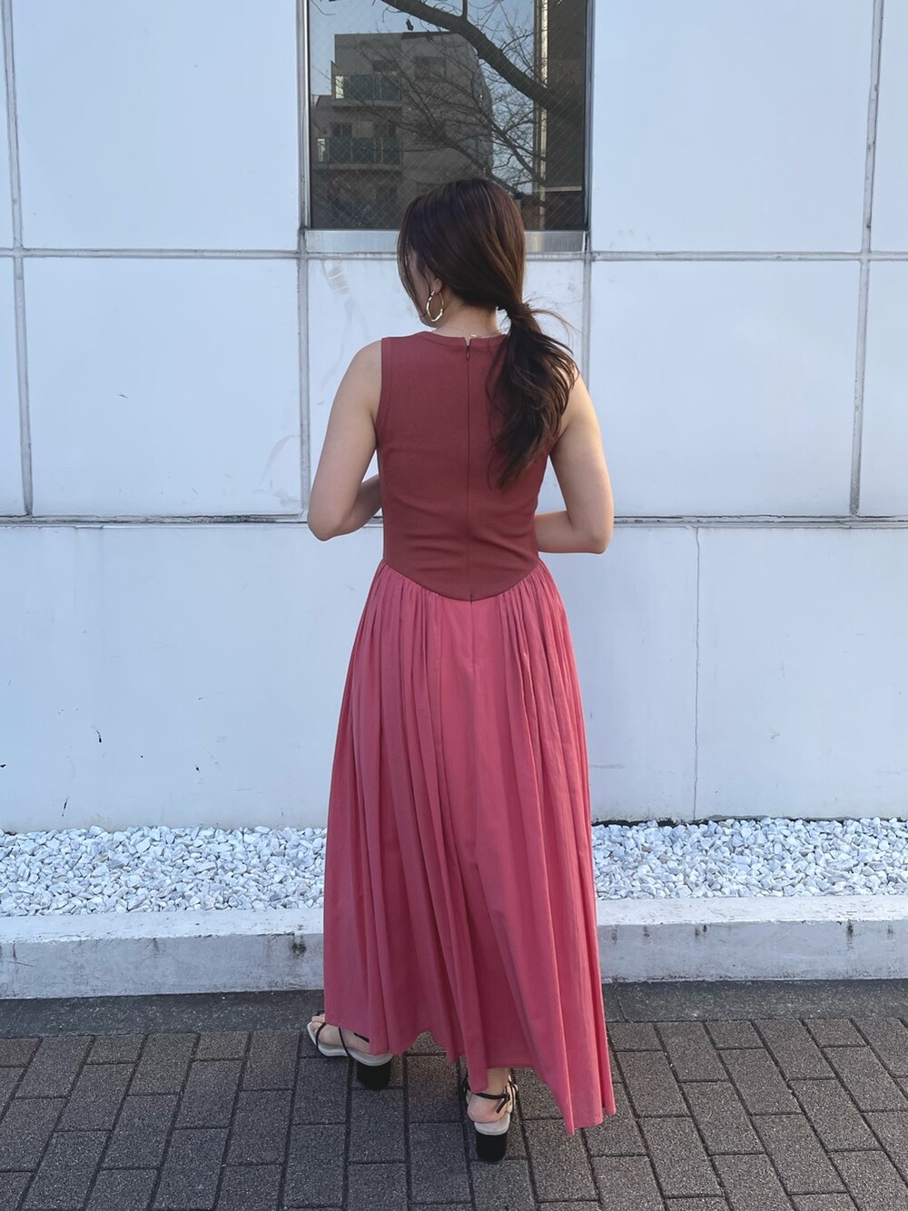 ブラック系のサンダル、ピンク系のワンピースを着用したレディースの春コーディネートの5枚目の写真