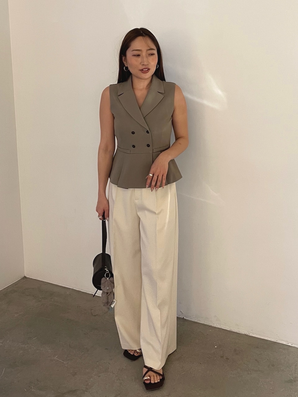 ブラウン系のサンダル、ブラウン系のベスト、ホワイト系のその他パンツを着用したレディースの春コーディネートの5枚目の写真
