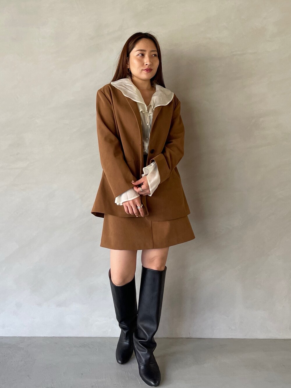 イエロー系のスカート、イエロー系のテーラードジャケット、ホワイト系のシャツ/ブラウスを着用したレディースの夏コーディネートの2枚目の写真