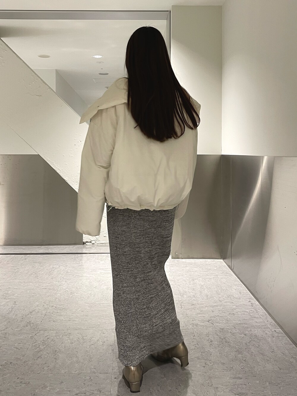 グレー系のワンピース、ホワイト系のダウンジャケット/コートを着用したレディースの冬コーディネートの5枚目の写真