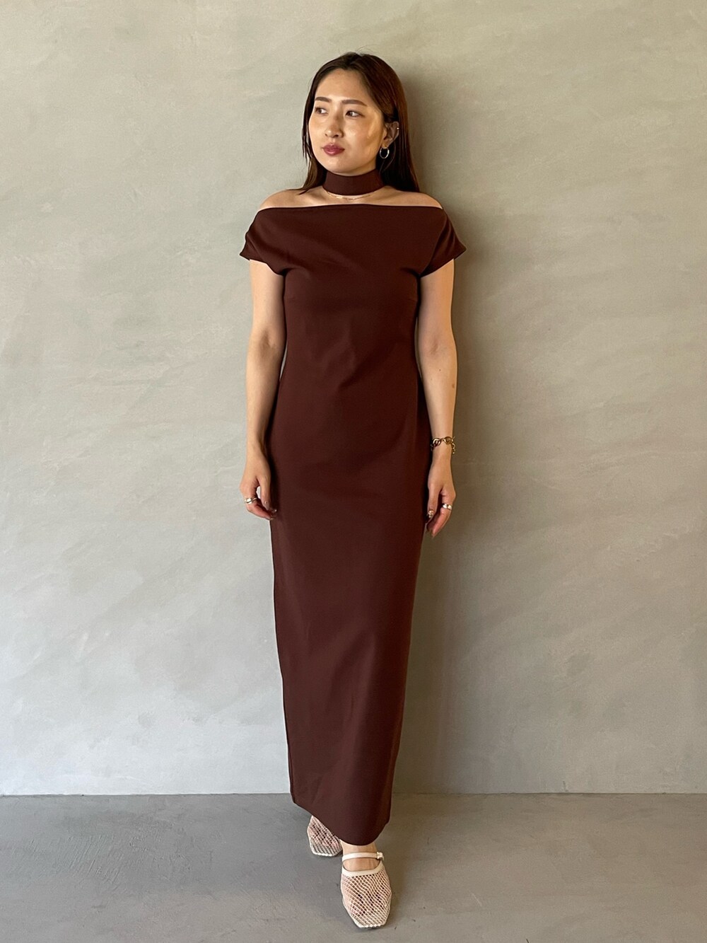 ホワイト系のサンダル、ブラウン系のワンピースを着用したレディースの夏コーディネートの2枚目の写真