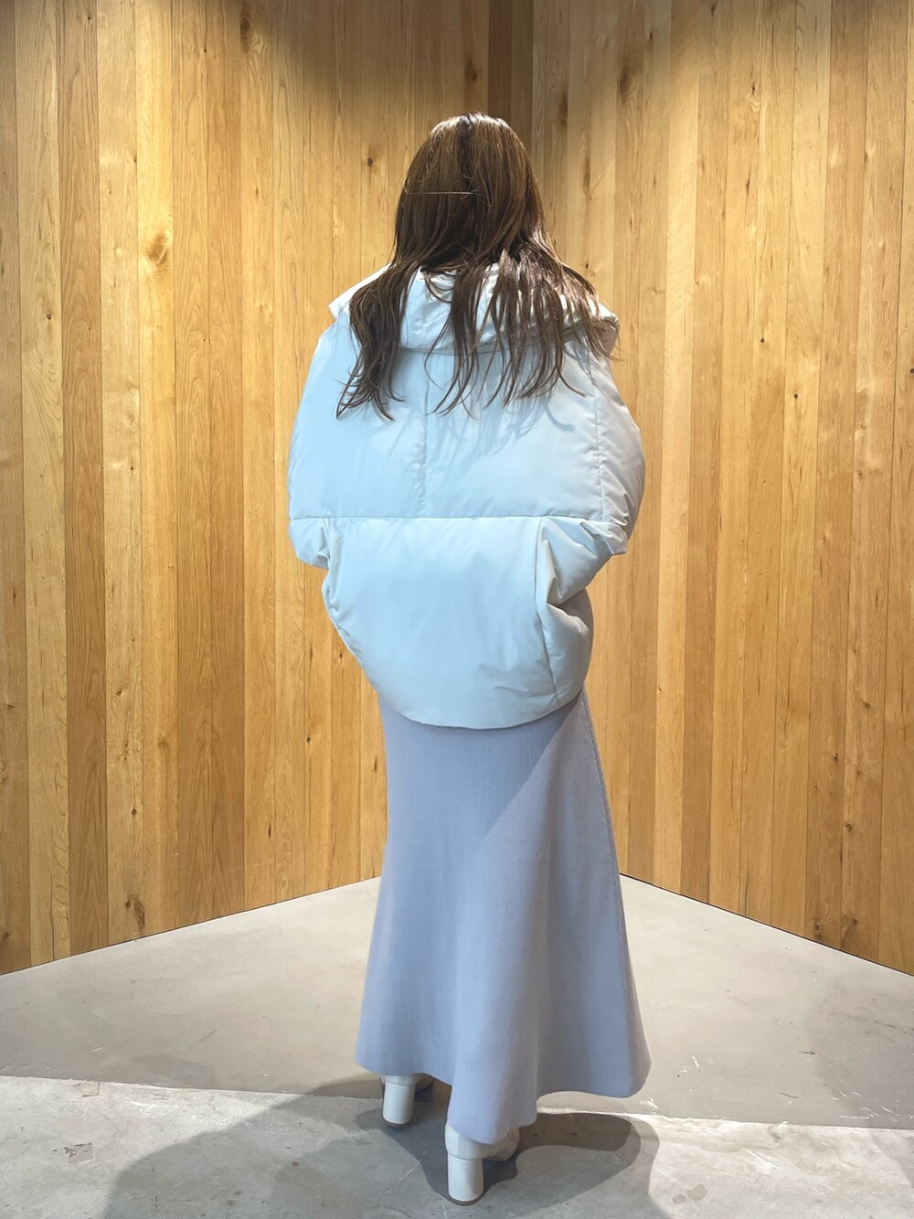 ホワイト系のブーツ、グレー系のワンピース、ホワイト系のダウンジャケット/コートを着用したレディースの秋コーディネートの7枚目の写真